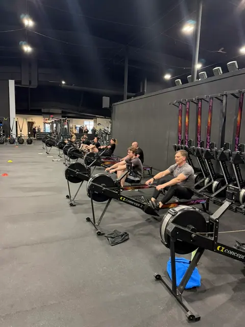 Iron Forge members rowing during class